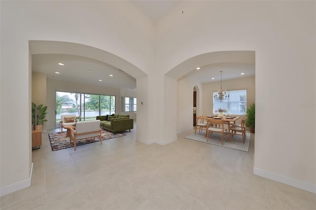 interior space with a notable chandelier and light tile patterned flooring