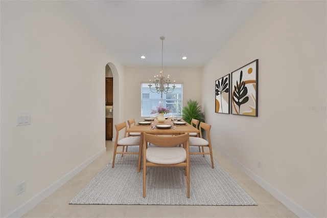 dining area with light tile patterned flooring and a chandelier