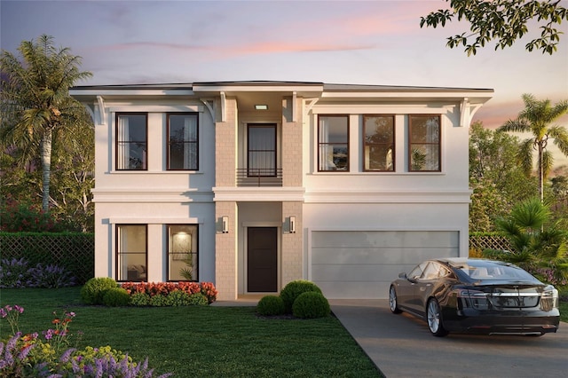 view of front of house featuring brick siding, fence, driveway, a lawn, and stucco siding