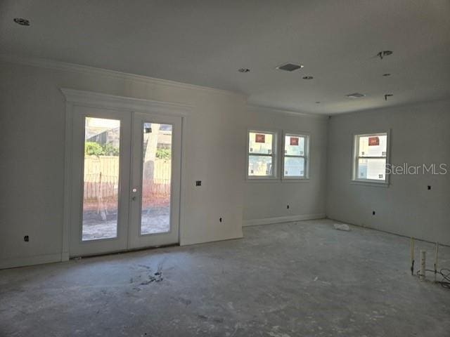 empty room featuring crown molding and french doors