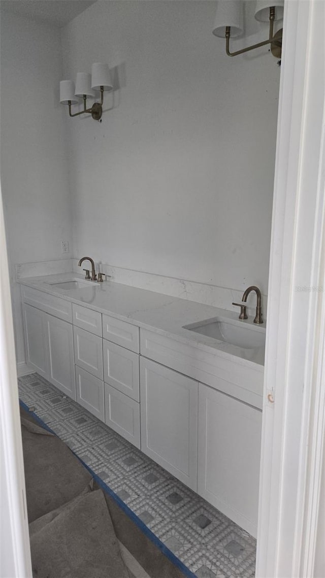 full bath featuring double vanity and a sink