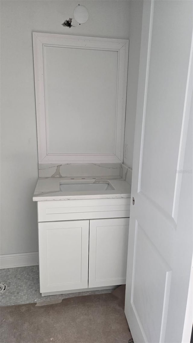 bathroom with baseboards and vanity