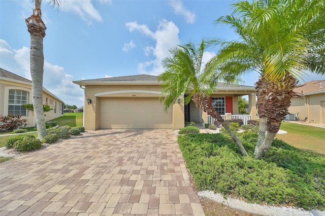 ranch-style home with a garage and a front yard