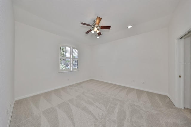 carpeted empty room featuring ceiling fan