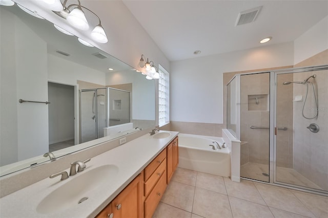 bathroom featuring dual bowl vanity, tile flooring, and separate shower and tub