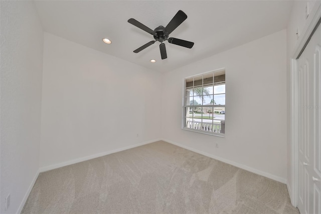 carpeted empty room featuring ceiling fan