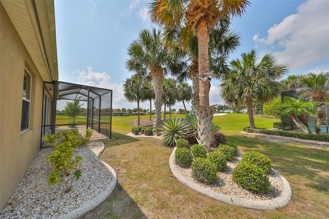 view of yard with glass enclosure