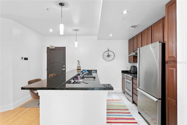 kitchen featuring light hardwood / wood-style floors, hanging light fixtures, white electric stove, stainless steel fridge, and kitchen peninsula