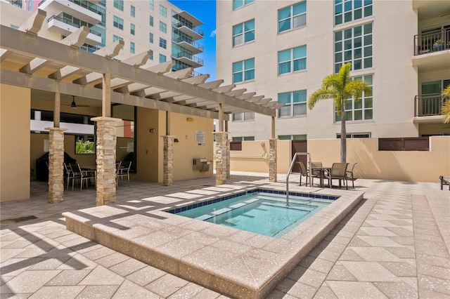 view of pool featuring a hot tub, a pergola, and a patio area