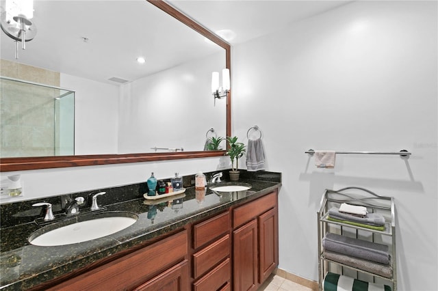 bathroom with tile floors, double sink, and vanity with extensive cabinet space