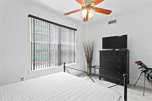 bedroom with light hardwood / wood-style floors and ceiling fan