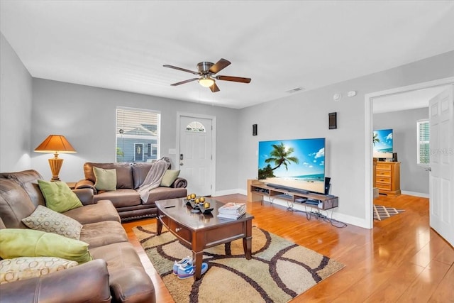 living room featuring ceiling fan and light wood-type flooring