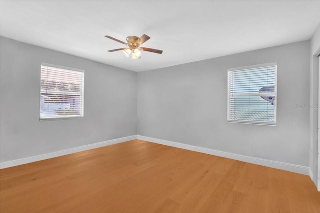 empty room featuring ceiling fan and hardwood / wood-style floors