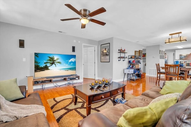 living room featuring light hardwood / wood-style floors and ceiling fan