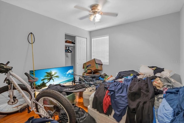 bedroom with ceiling fan, a closet, and hardwood / wood-style flooring