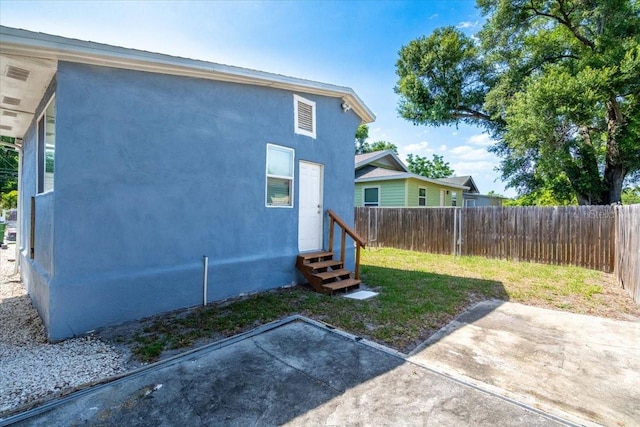 view of side of home featuring a patio