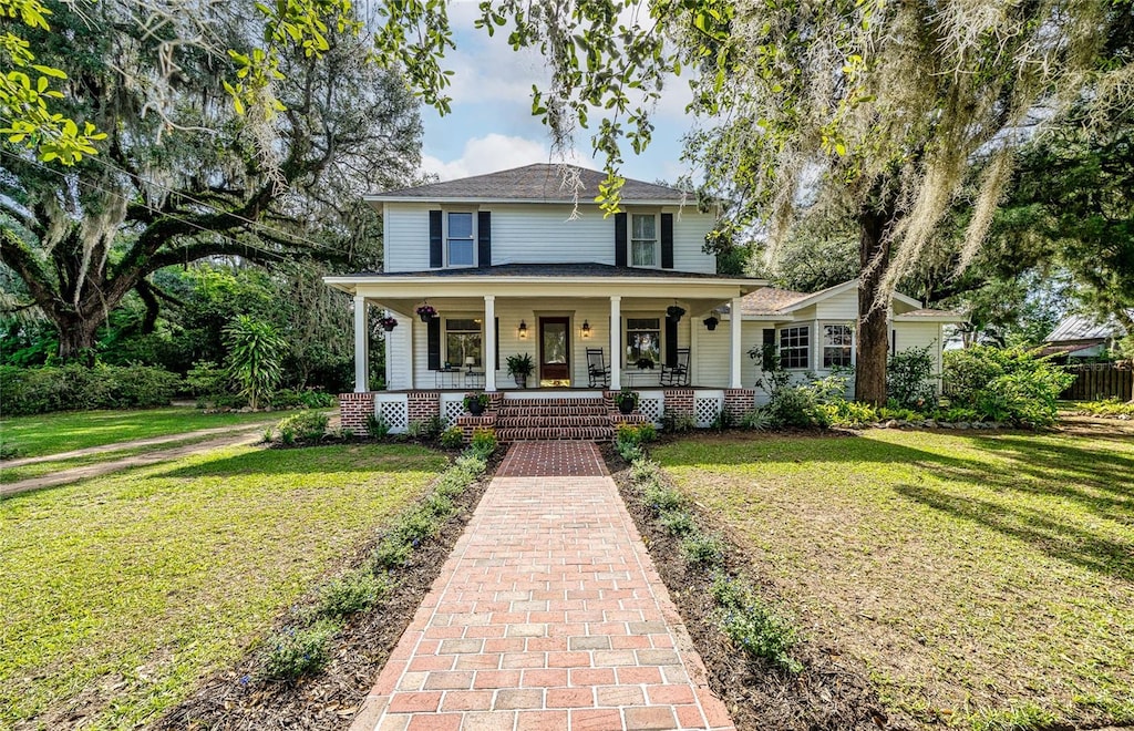 view of front of home featuring a front yard and a porch