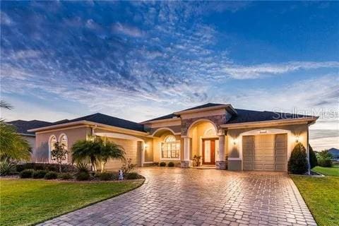 view of front of property with a garage and a front lawn