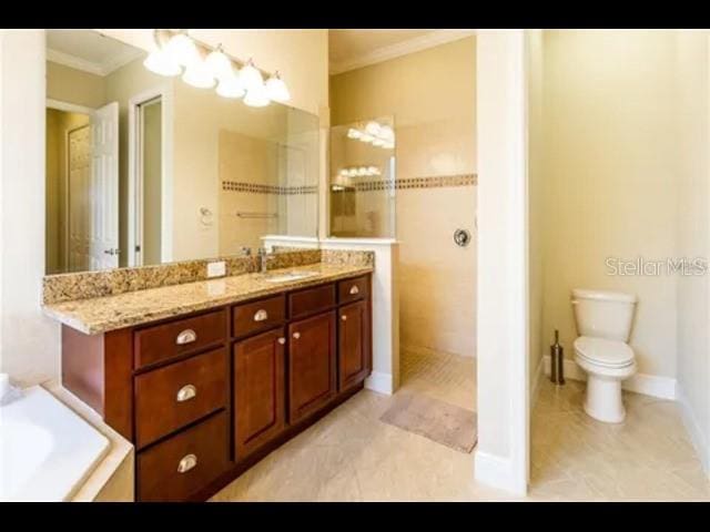 bathroom with ornamental molding, toilet, vanity, and tile patterned flooring