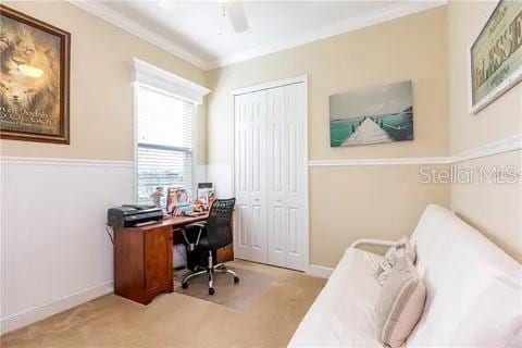 carpeted home office with crown molding and ceiling fan