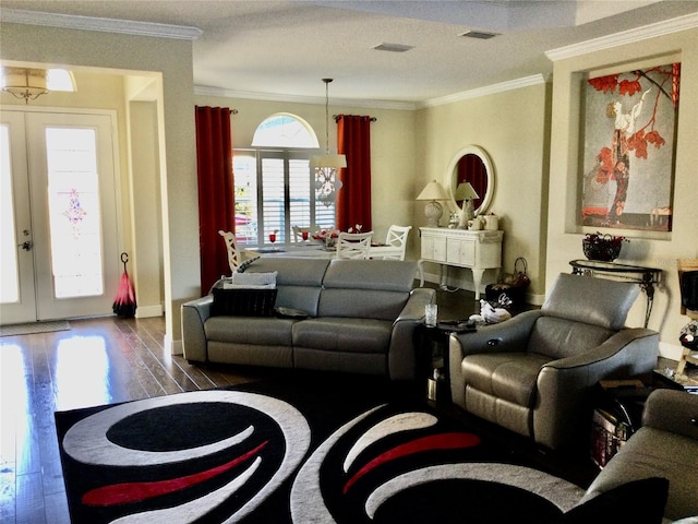 living room featuring dark hardwood / wood-style flooring, ornamental molding, and french doors