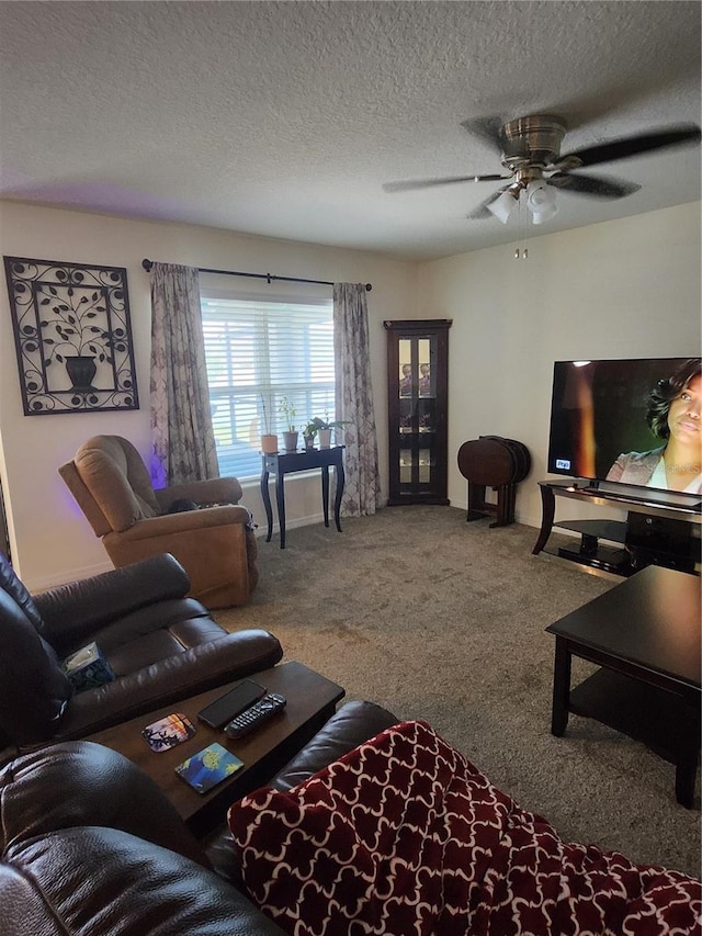 living room featuring ceiling fan, a textured ceiling, and carpet floors