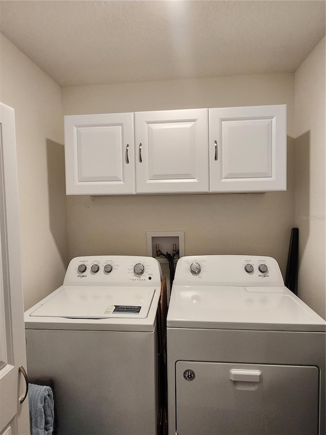 laundry area with cabinets and independent washer and dryer