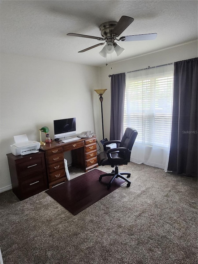 office featuring a textured ceiling, carpet, and ceiling fan