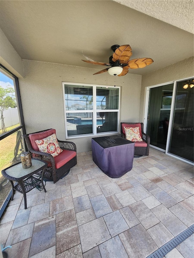 sunroom with ceiling fan