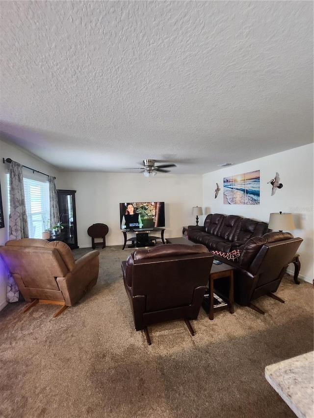 carpeted living room with a textured ceiling and ceiling fan