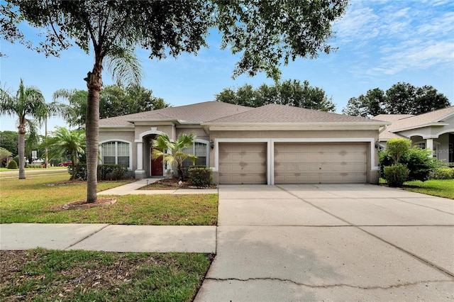 ranch-style house with a garage and a front lawn