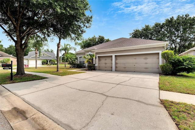 view of front of home featuring a garage, concrete driveway, a front lawn, and stucco siding