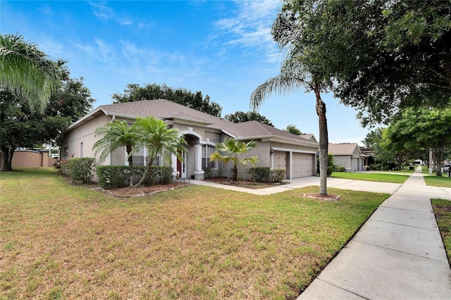 view of front of house with a garage and a front lawn