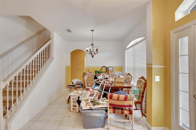 dining area featuring a chandelier and light tile floors