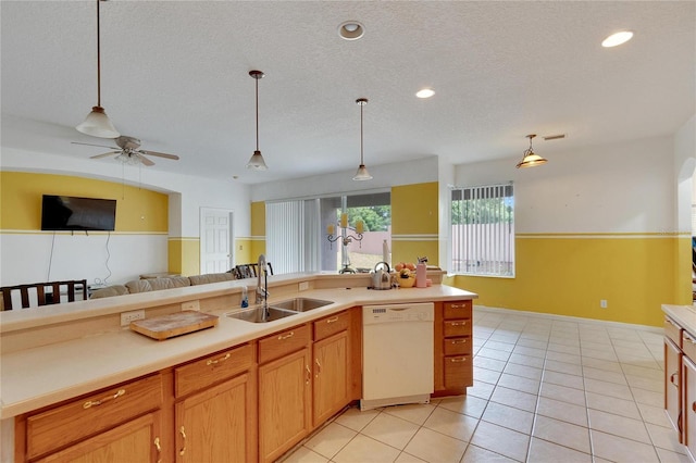 kitchen with white dishwasher, hanging light fixtures, sink, light tile flooring, and ceiling fan