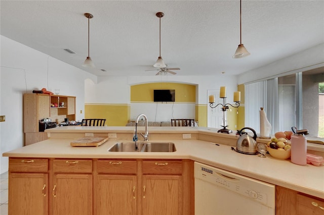 kitchen featuring a textured ceiling, hanging light fixtures, ceiling fan, sink, and dishwasher