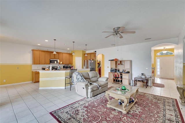 tiled living room featuring ceiling fan