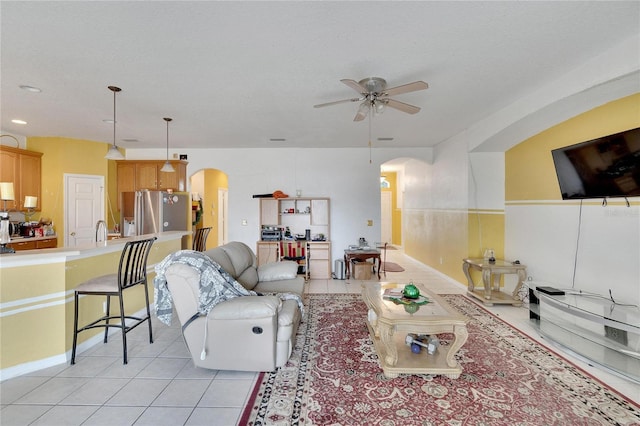 tiled living room with ceiling fan