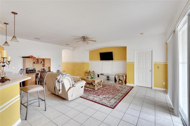 living room with ceiling fan and light tile floors