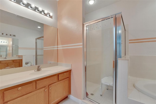 bathroom featuring independent shower and bath and vanity with extensive cabinet space