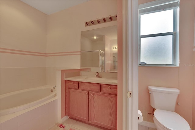 bathroom with a healthy amount of sunlight, vanity, toilet, and tile floors