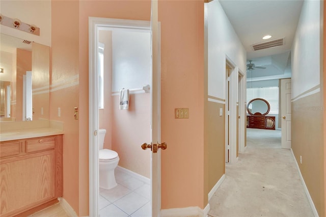 bathroom with vanity, toilet, and ceiling fan