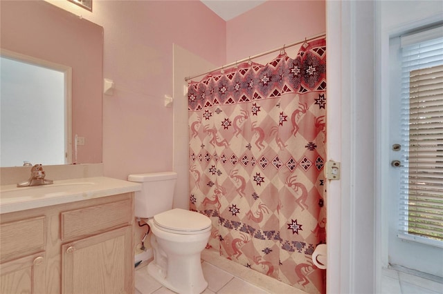 bathroom featuring tile floors, toilet, and vanity