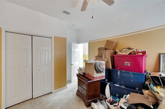 interior space featuring ceiling fan and light colored carpet