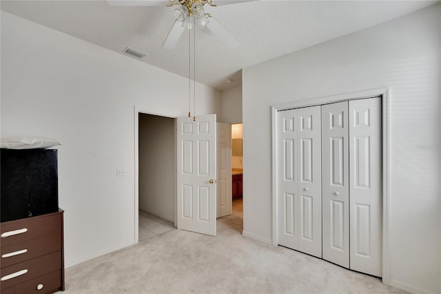 carpeted bedroom with a closet and ceiling fan