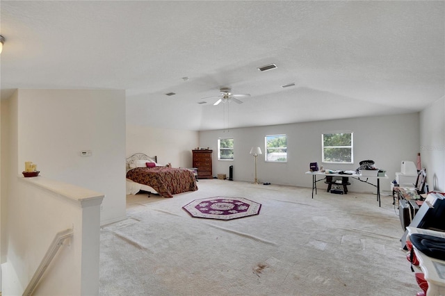 interior space with ceiling fan, a textured ceiling, and light colored carpet