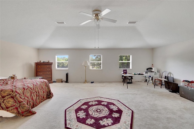 bedroom with a textured ceiling, carpet flooring, and ceiling fan