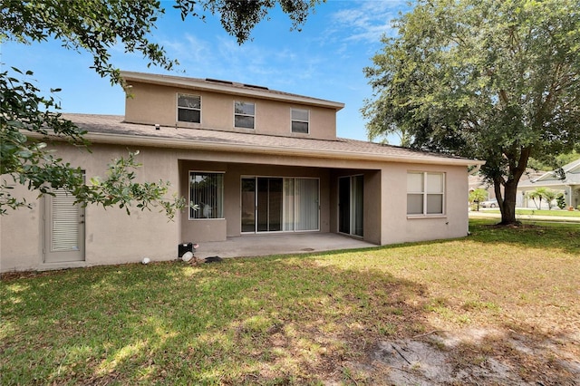 rear view of house with a yard