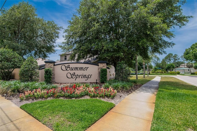 community / neighborhood sign with a yard