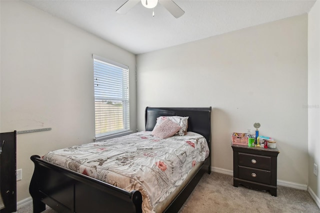 bedroom featuring ceiling fan and light carpet